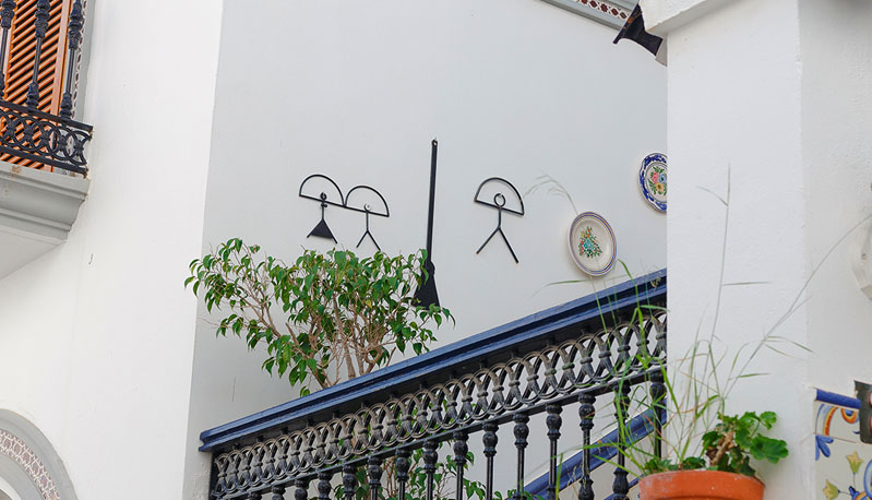 A picture of multiple Indalo Men hanging from a wall